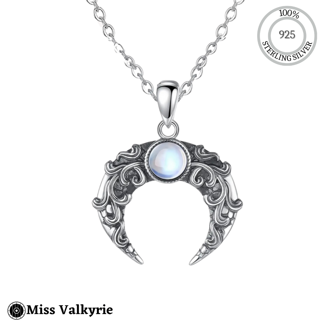 Sterling silver blue moon crescent necklace with intricate filigree design and glowing blue stone pendant