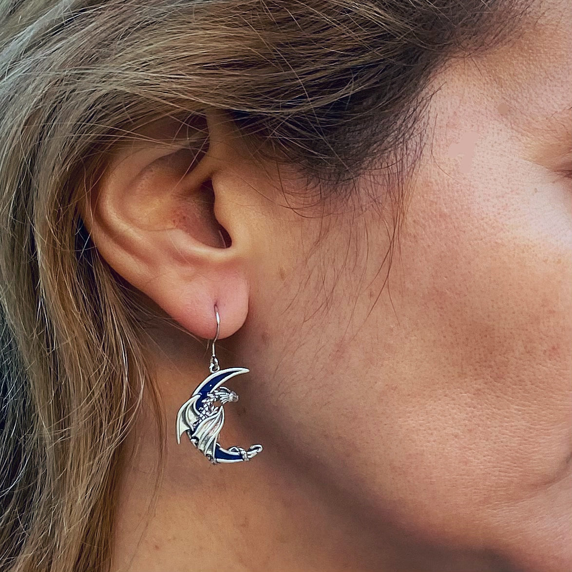 Sterling silver dragon earrings worn on ear featuring detailed dragon design by Miss Valkyrie