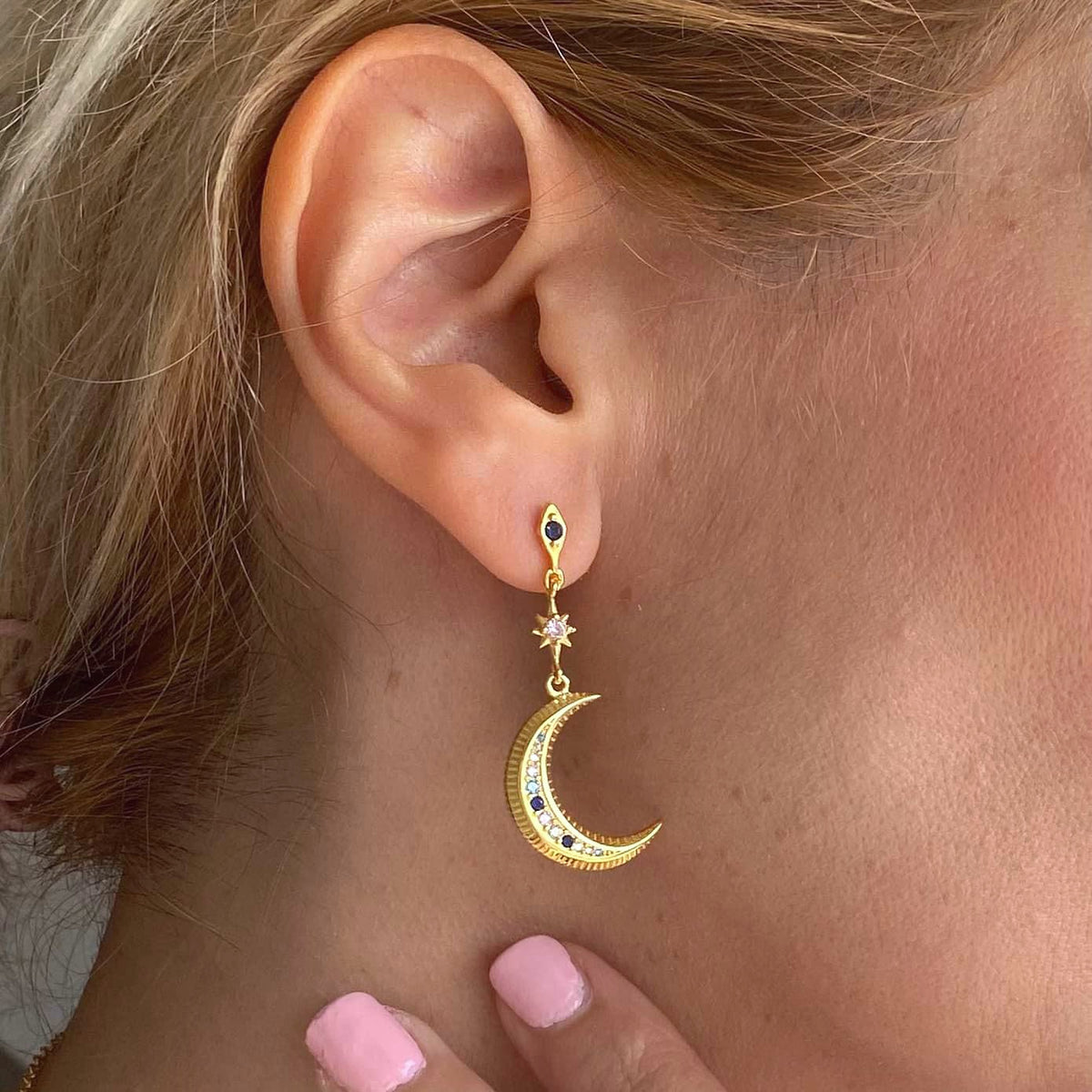 Sterling silver mismatched earrings moon sun gold plated 18k earrings worn on ear with crescent moon design