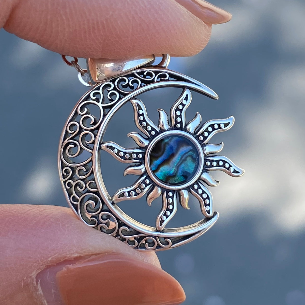 Sterling silver moon crescent sun necklace with intricate swirl design and abalone center pendant