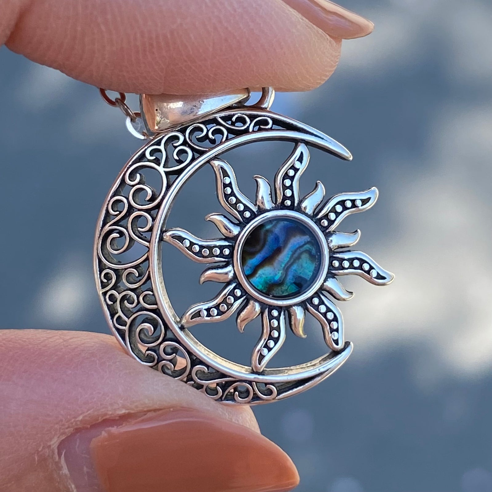 Sterling silver moon crescent sun necklace with intricate swirl design and abalone center pendant