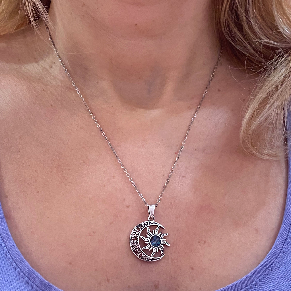 Sterling silver moon crescent sun necklace worn on a woman with a lavender top by Miss Valkyrie