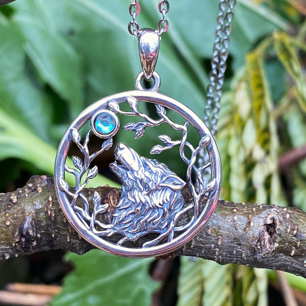 Sterling silver moon wolf leaves necklace with blue gemstone pendant hanging on chain
