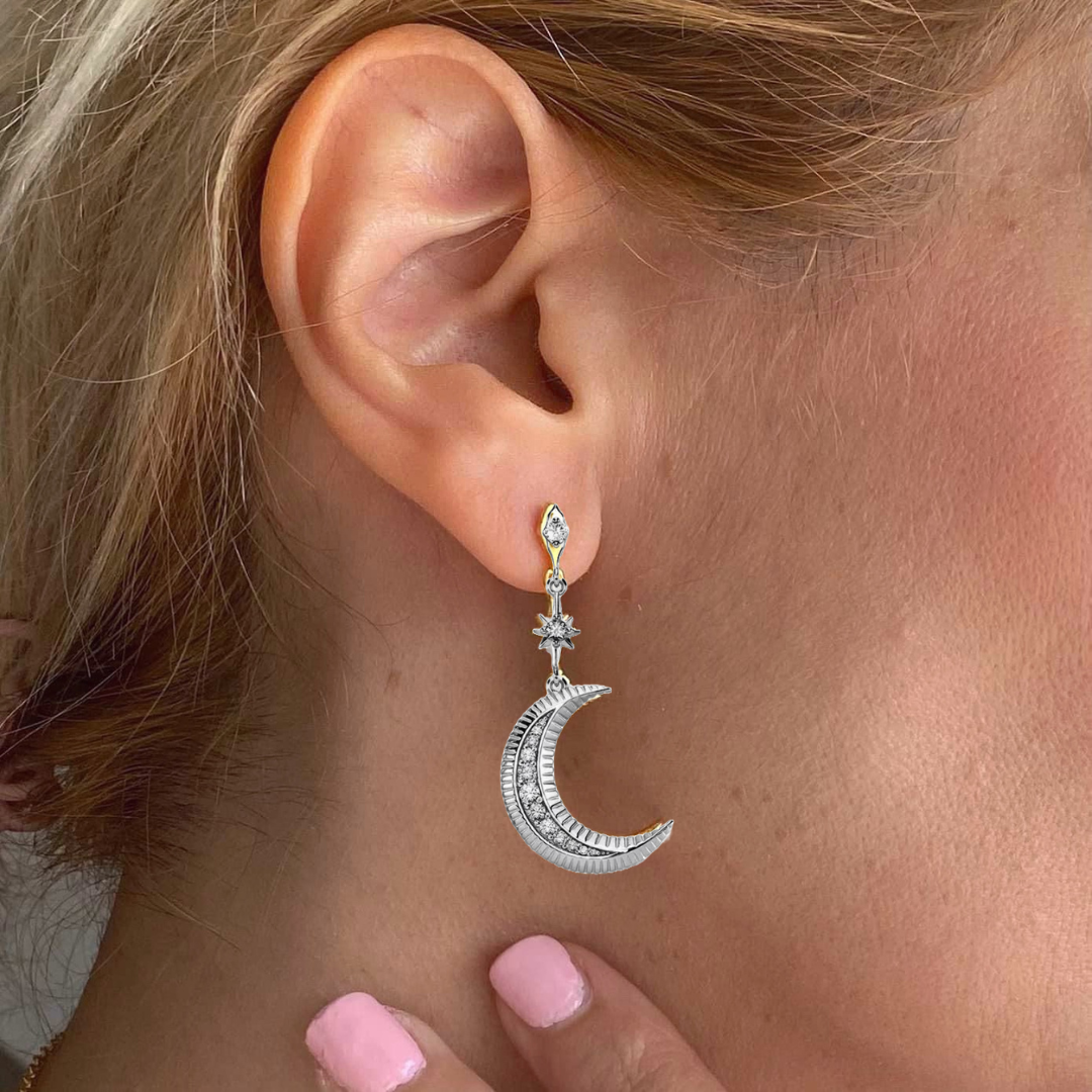 Sterling silver Star moon mismatched earrings worn on ear featuring detailed crescent moon and small star design