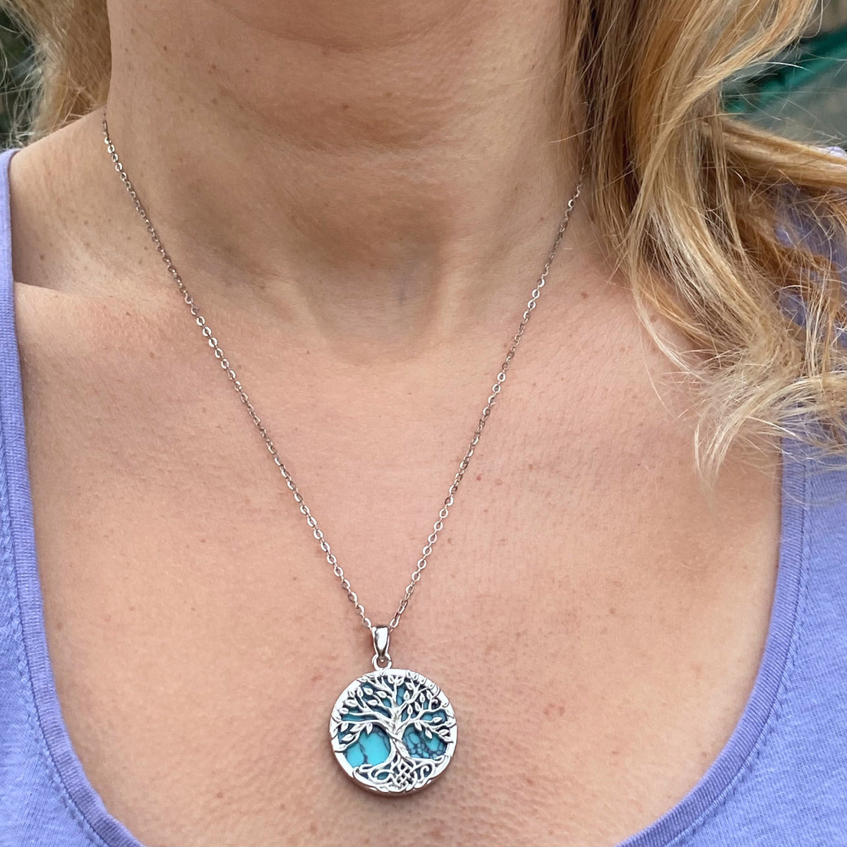 Sterling silver turquoise yggdrasil tree of life necklace worn on neck with detailed tree design pendant