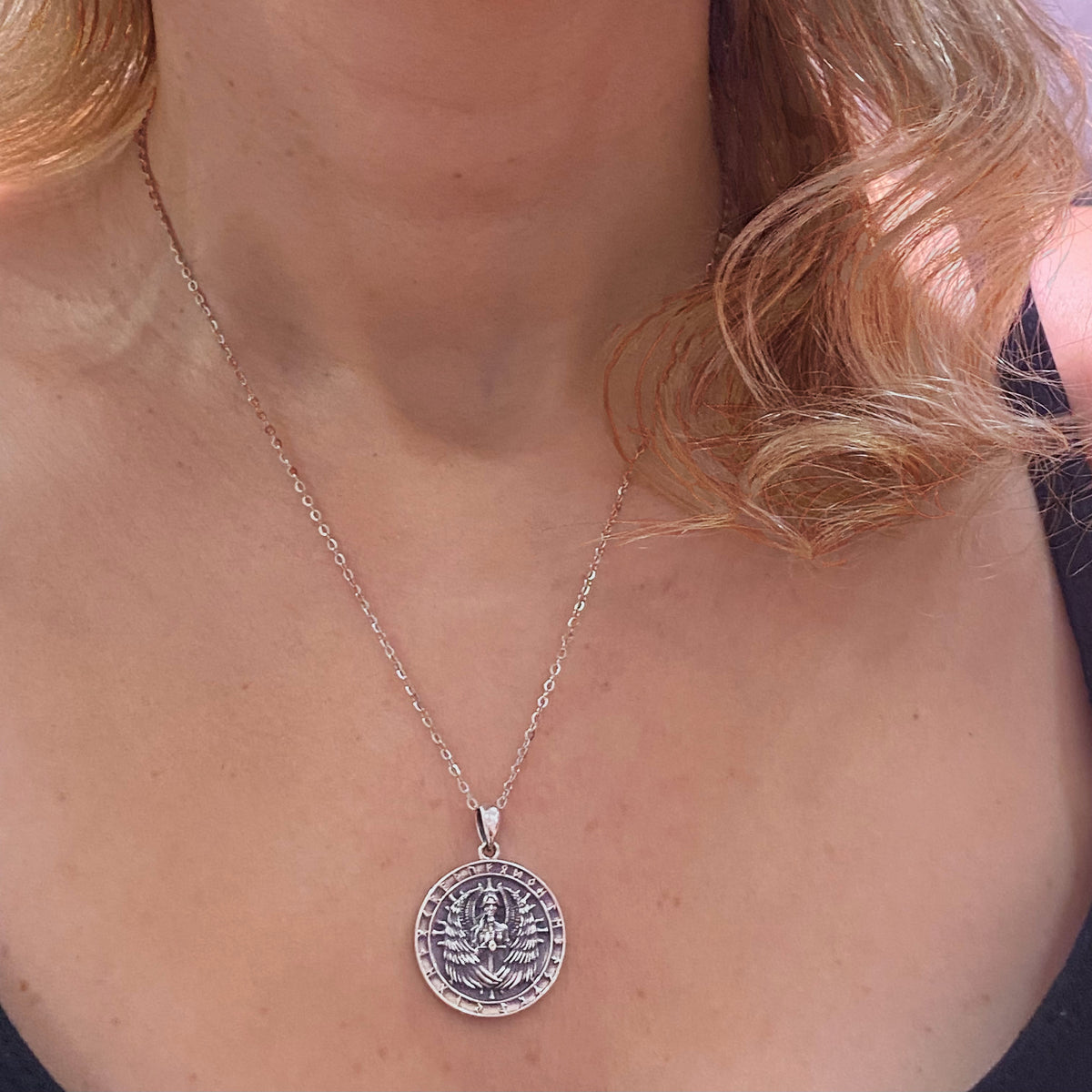 Sterling silver Valkyrie necklace worn on a woman with curled blonde hair and black top