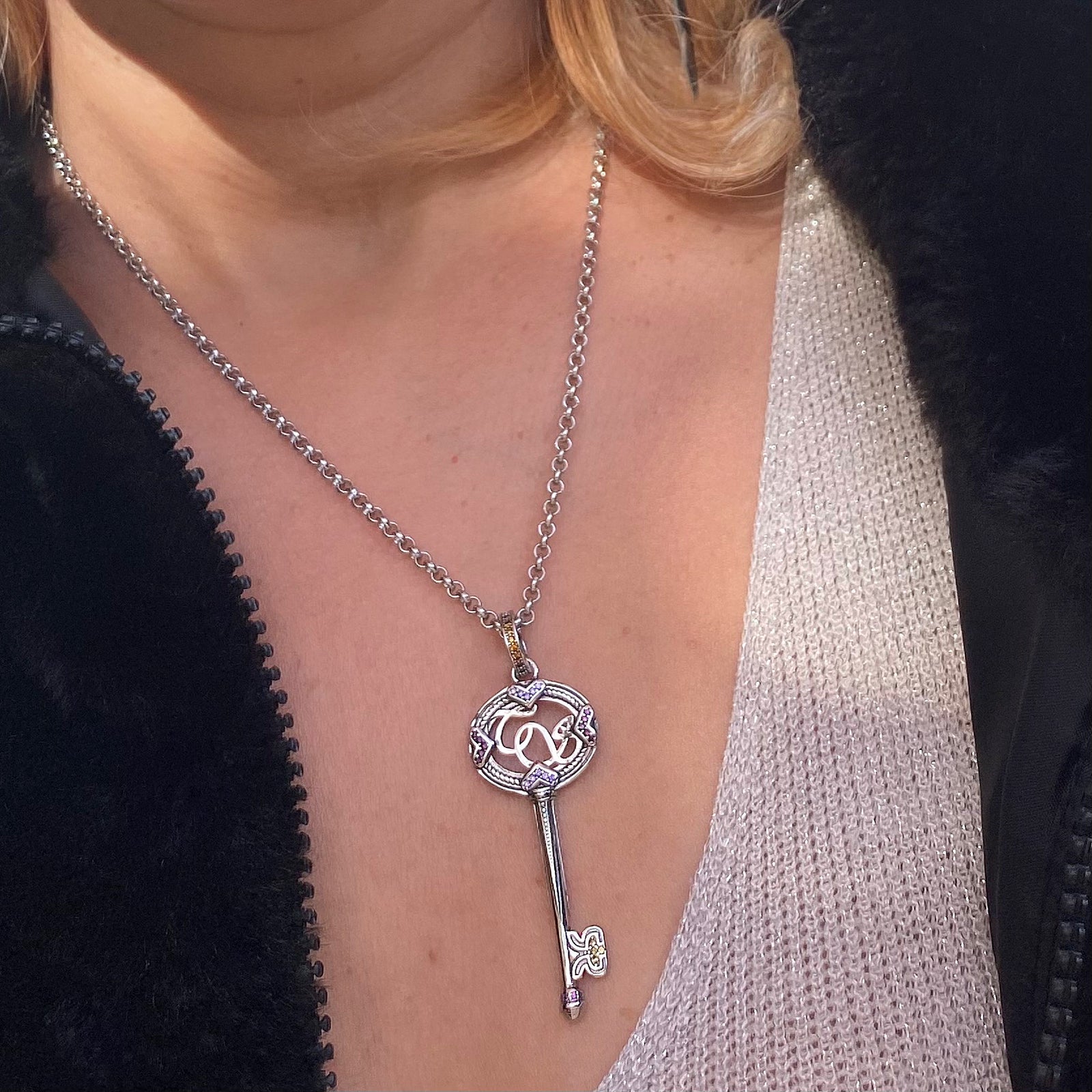 Sterling silver Viking key necklace worn around neck with detailed key pendant on chain