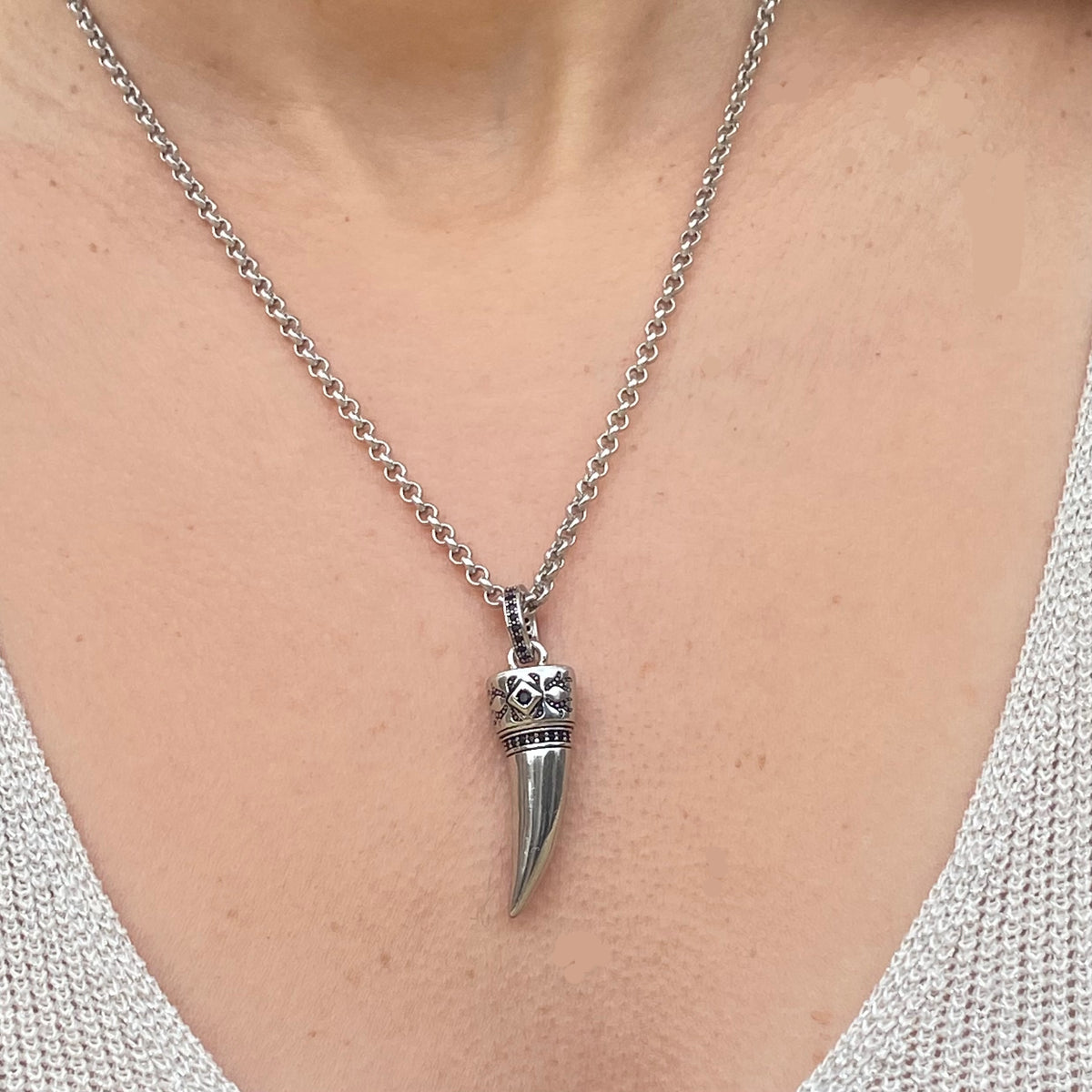 Sterling silver wolf tooth necklace with detailed crown pendant worn on a silver chain