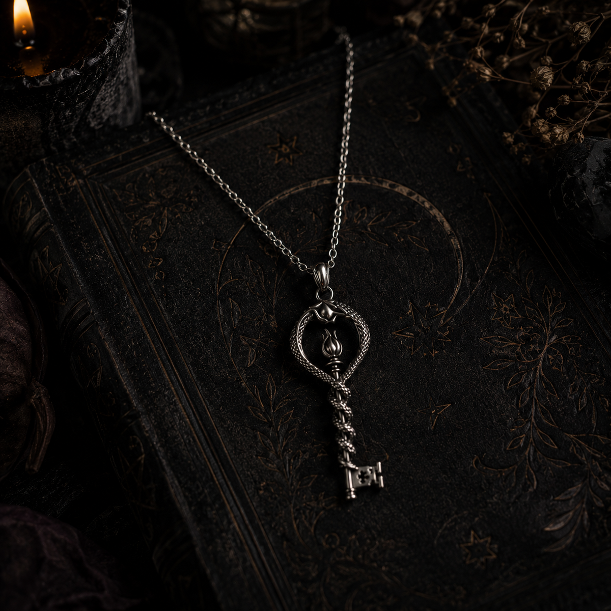 Torch Hekate Key Necklace on a dark, textured background with mystical decor