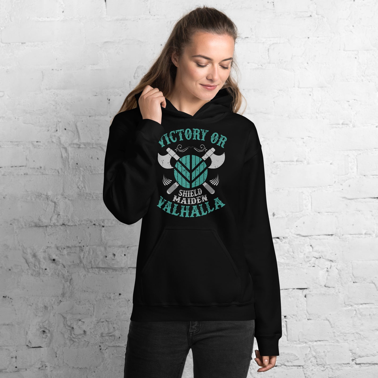 Woman wearing black Victory or valhalla hoodie with teal and white Viking shield and axes design